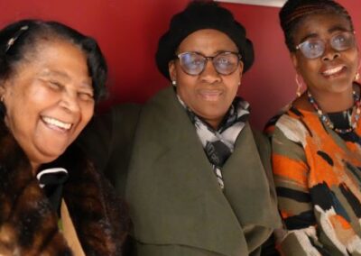 three people smiling at the camara